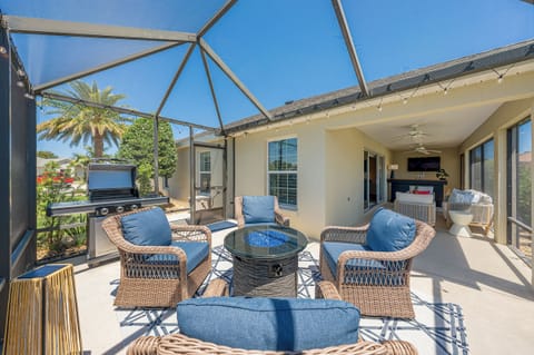 Sprawling Screened-in Lanai w/ Remote Controlled Privacy Shades, Fire Table, Ample Lounge Seating, Bar, Flatscreen TV,  & Brand New Gas Grill