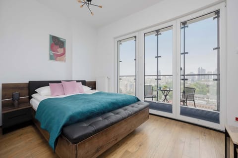 Modern studio apartment with panoramic city view and large windows