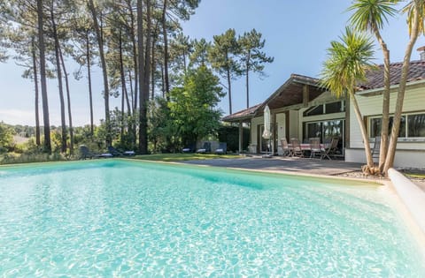 Pool terrace, tall pine trees, blue sky:<br>Soak up the Landes sunshine beside your private pool.