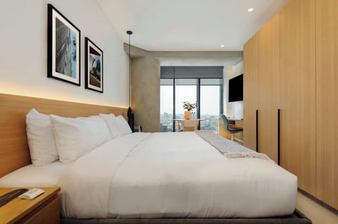 Cozy bedroom with a plush bed and natural light.
