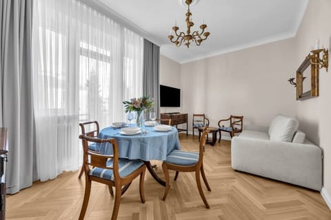Elegant Living Room with Dining Area, Classic Décor & Large Windows | Book Now with RENTUJEMY.COM