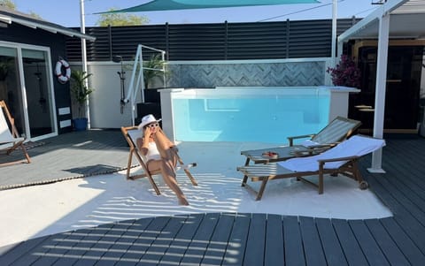 Relax on your private white-sand grounding beach beside the heated glass pool—your own wellness escape in Downtown Phoenix.