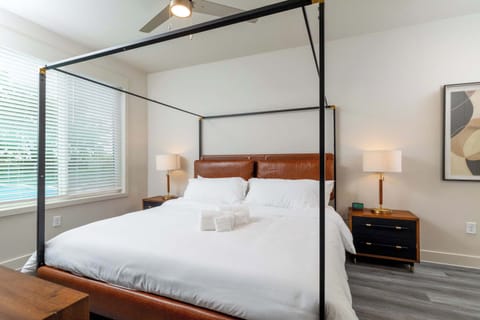 Primary bedroom showcases a king bed, large windows for natural light, and an attached bathroom for added convenience.