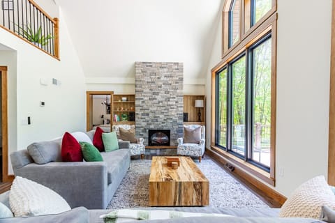 Sun-drenched living room with a cozy stone gas fireplace - perfect for slow mornings and fireside nights