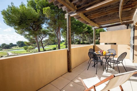 Dine al fresco under the pergola with sweeping views of the Saumane Golf Course right at your feet.
