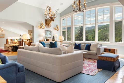 Spacious and elegant living room with vaulted ceilings, fireplace, and tons of natural light