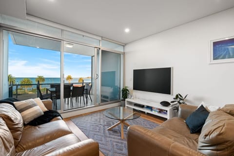 The Southern Ocean holds the room`s attention from every seat, floor-to-ceiling glass framing the view while the leather lounge suite and flat-screen TV keep evenings easy.