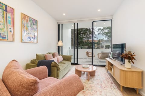 Sink into the comfy lounge and make yourself at home in this warm and inviting living space, perfect for relaxing after a busy day.