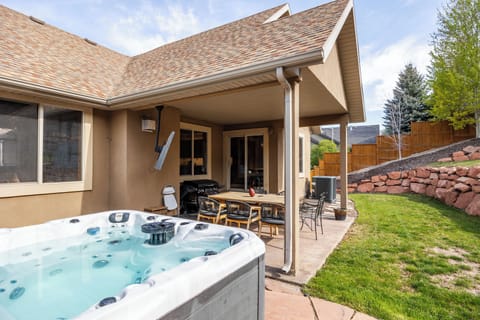 Relax in the private outdoor hot tub and enjoy the spacious patio area, perfect for unwinding after a day of adventure.