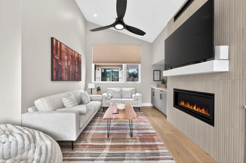 Unwind in your stylish living space featuring a cozy fireplace, modern amenities, and comfortable seating perfect for relaxing evenings.