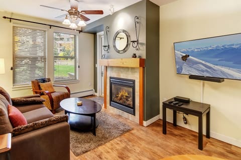 Sink into plush seating by your own fireplace, with a large TV and mountain views setting the scene for cozy evenings after exploring the slopes.