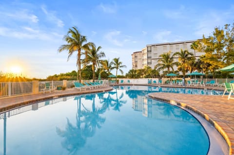 Bask in the sun by the pool, where the flickering water reflects the golden hues of sunset.