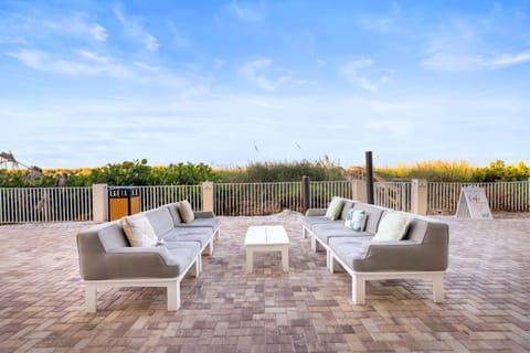 Gather with friends on spacious couches, perfect for unwinding with a drink after a day at the beach.