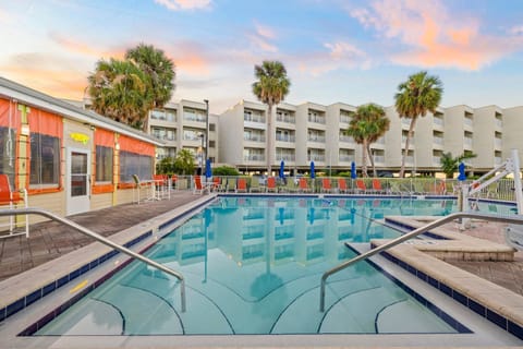 Unwind under the setting sun with a drink at the poolside bar, just steps away.