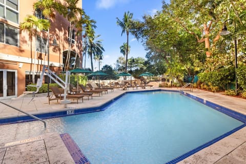 Take a refreshing dip in the inviting pool, just steps away from shaded lounge areas.