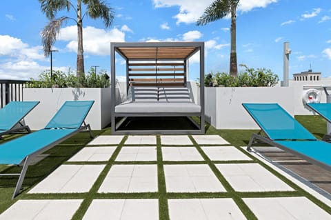 Cozy up in this inviting cabana, surrounded by lush greenery and sunshine.