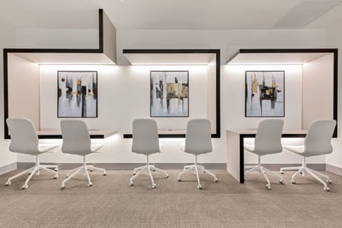Enjoy collaborative work in this inviting space, featuring sleek designs and vibrant artwork.