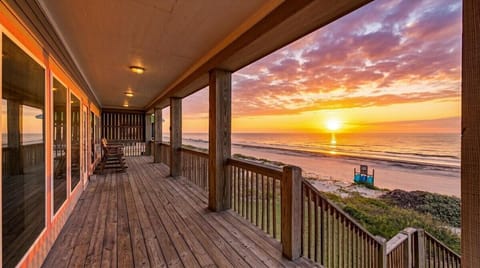 Spacious beachfront deck with panoramic Gulf views, covered outdoor seating, and direct sunrise views in Port Bolivar vacation rental near Crystal Beach.