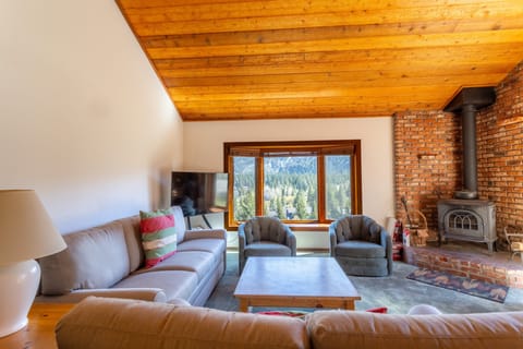 Living room has wood burning fireplace and private deck.