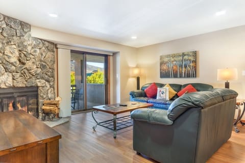 Cozy living area with fireplace and walkout balcony- main condo