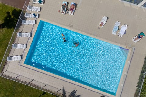 A bird's-eye view of the outdoor pool, surrounded by the residence's tranquil pedestrianised grounds.