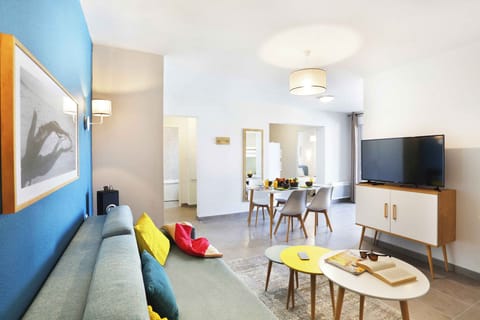 Relax on the comfy sofa, enjoying a book or your favorite show with a colorful splash of decor all around.