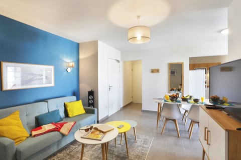 Gather around the dining table for a delightful meal in this cheerful living space.