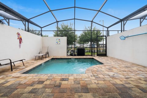 Private screened pool area with lounge chairs and a clear view of the sky