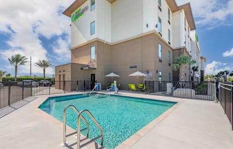 Arrive and unwind beside the resort-style pool and loungers.