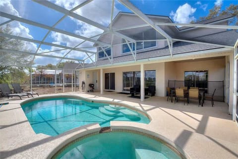 Sparkling screened-in pool w/ patio seating — your private backyard escape.
