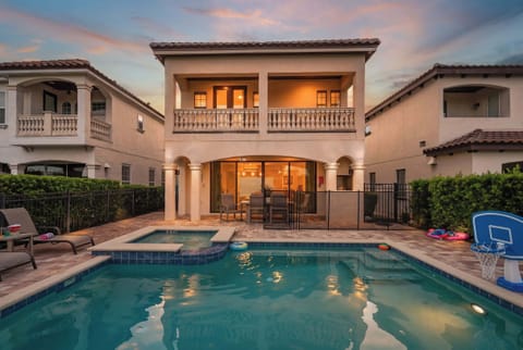 Modern home with a private pool and covered patio for outdoor dining.