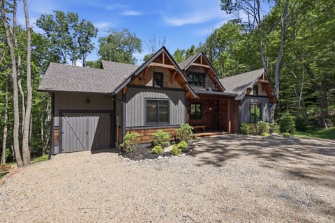 Rustic woodland cabin featuring a private forest setting and inviting curb appeal — a warm, charming retreat that sets the tone for a perfect mountain getaway from the moment you arrive.