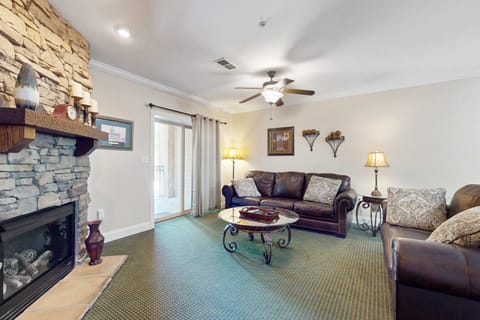 Stone fireplace and natural light create an inviting space for relaxation.