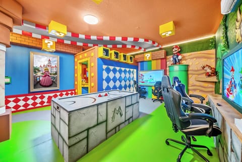 Experience a vibrant gaming paradise with playful colors and unique decor, where bright green floors and whimsical wall art blend perfectly with charming gaming consoles, creating an energizing atmosphere for everyone to enjoy.