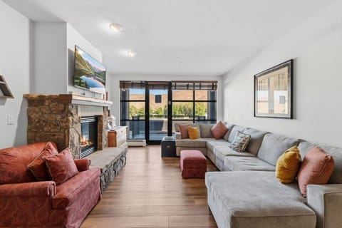 Living room with fireplace, smart tv and stunning mountain views