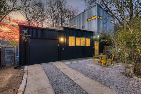 Private backyard and exterior of this modern East Austin vacation home at sunset.
