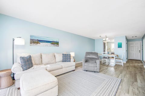 Bright coastal living room with spacious seating and open dining area