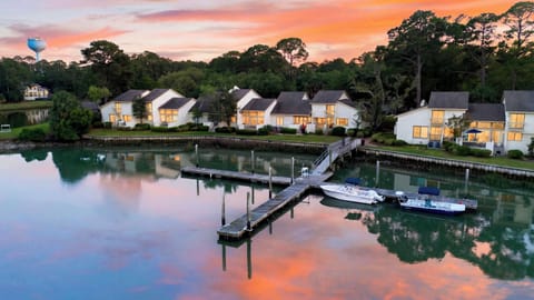 Sunset reflections and dock access create a serene waterfront setting for your coastal escape.
