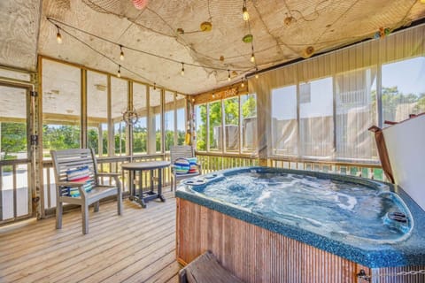 Unwind in your private screened porch hot tub, surrounded by nature views and playful coastal decor—your perfect escape after a day of adventure.