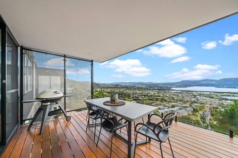 Dine outdoors on the covered balcony with the barbecue sizzling nearby and uninterrupted views stretching across the River Derwent and surrounding hills.