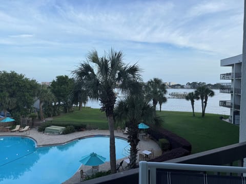 Private balcony overlooking the resort-style pool & beautiful bay views.