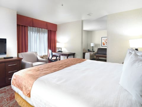 Recharge in a bright king bed with plush pillows.