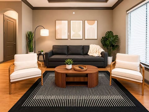 Warm, stylish living room with modern seating, cozy lighting, wood accents, and a clean, inviting layout.