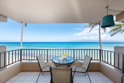 Relax outdoors with a glass‑top dining table and uninterrupted views of the blue Pacific.