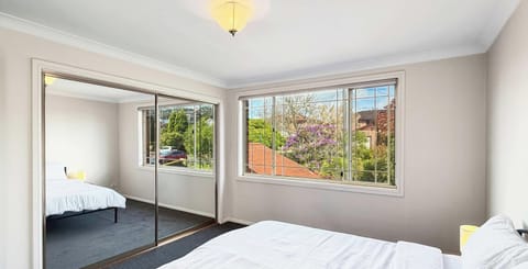 Bright bedroom with mirrored wardrobe
