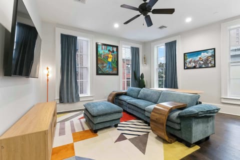 Brass Band Room — a vibrant New Orleans tribute styled by local artists. Original works by Kerri Wilkinson, Herb Leonard, Patrick Henry, and Ceaux celebrate the city’s legendary brass-band culture just steps from the parade route.