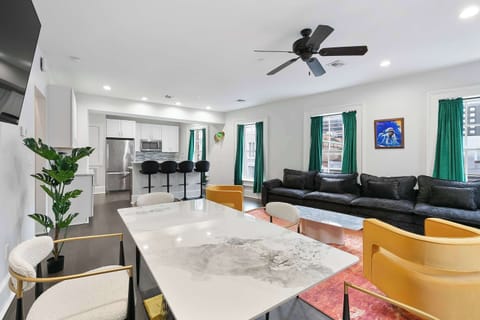 Gallery-style suite with real instruments mounted as art, vibrant local décor, and bold creative energy inspired by New Orleans funk and music culture.