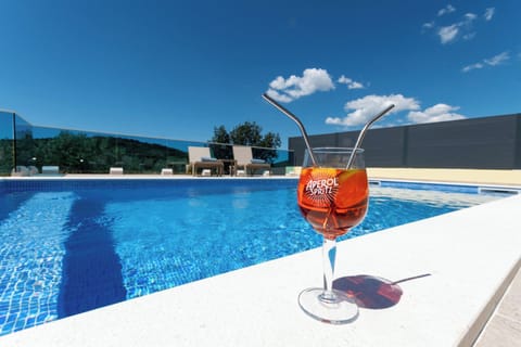 Outdoor pool, a heated pool, open open 24 hours, pool umbrellas