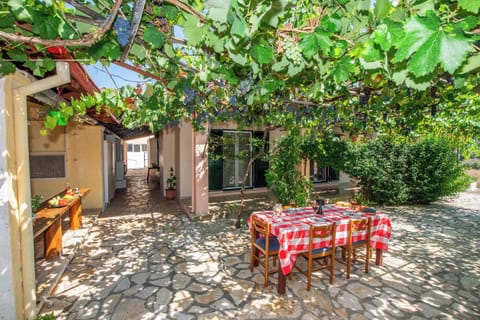 Shaded outdoor dining area surrounded by greenery