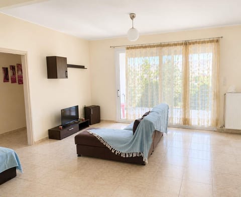 Bright and spacious living area with direct balcony access, natural daylight, and comfortable open-plan spaces designed for relaxing stays near the sea and marina.